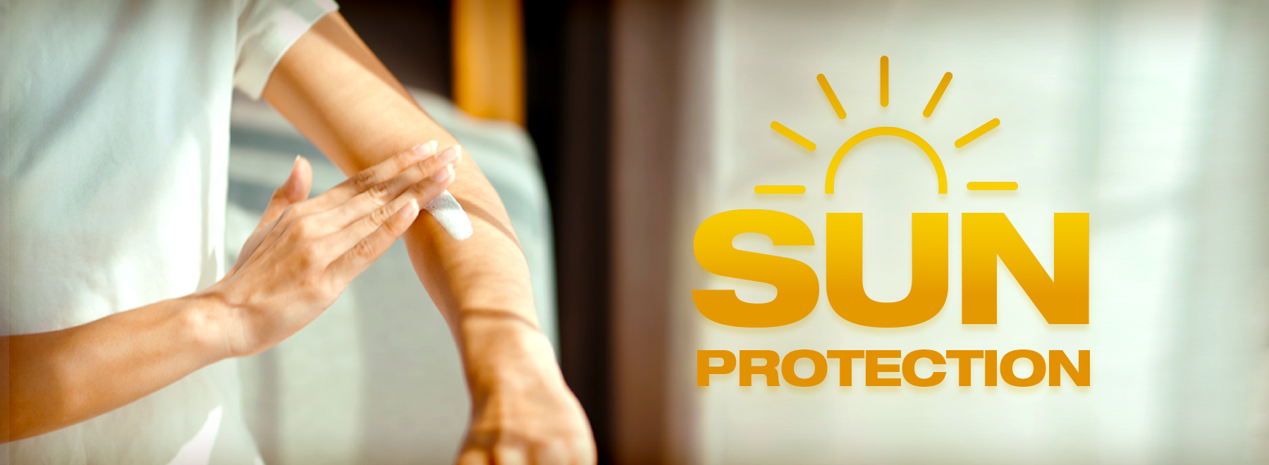 Close-up of sunscreen being applied indoors, emphasizing summer sun protection tips.